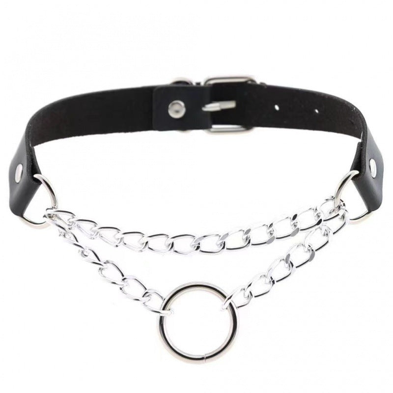 Black leather femboy choker with silver chain and metal O-ring centerpiece, adjustable snap buttons, gothic femboy fashion accessory on white background