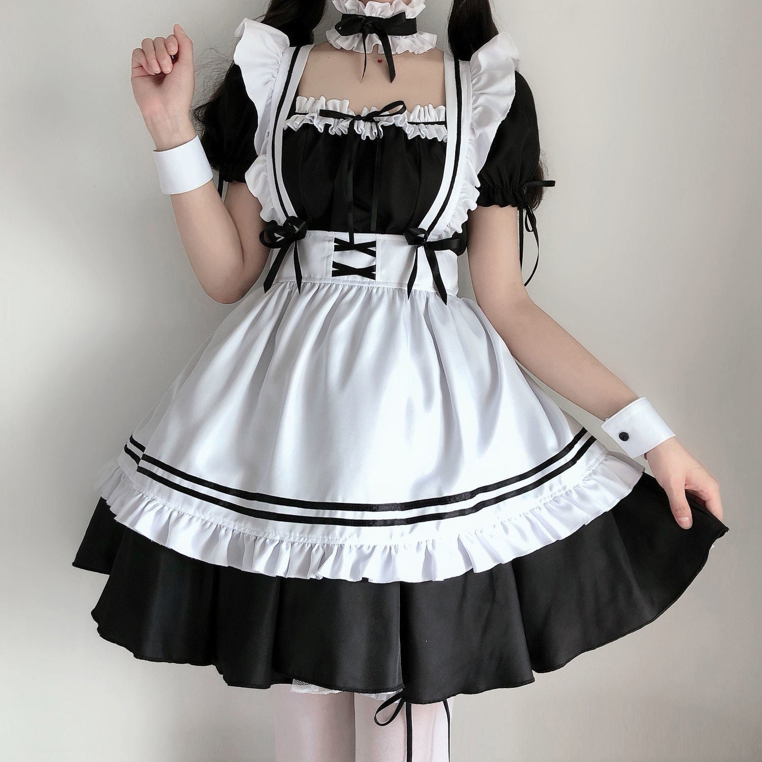 Stylish femboy outfits, showcasing a maid's attire with detailed ruffle trim and a satin finish, blending classic charm with modern femboy aesthetics.