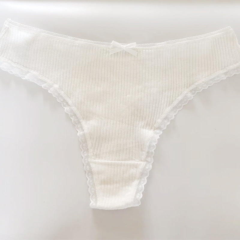 Flat-lay of a white Bowknot Lace Trim Thong featuring ribbed fabric, lace trim, and a subtle bowknot. Perfectly styled on a clean background, showcasing feminine femboy outfits.