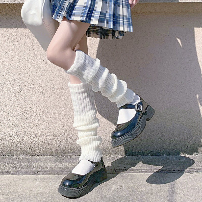 White knitted leg warmers matched with platform shoes and pleated skirt, soft cute femboy aesthetic